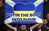 Football supporters show their support to Ukraine during an international soccer match between Scotland and Poland at Hampden Park stadium in Scotland, March 24 2022.