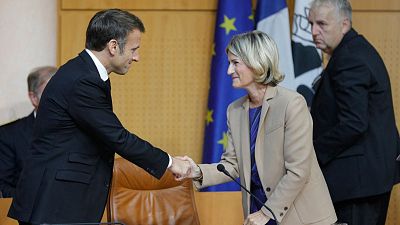 Emmanuel Macron shakes hands with the President of the Corsican Assembly Marie-Antoinette Maupertuis before addressing a session of the Corsican Assembly in Ajaccio.