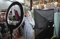 A woman conducts live sales via streaming at a store in the Tanah Abang textile market in Jakarta, Indonesia on September 28, 2023.