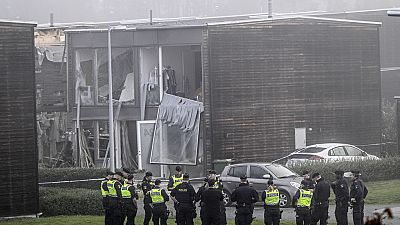 Police stand on the site of a powerful explosion that occurred early Thursday morning Sept. 28, 2023, in a housing area in Storvreta outside Uppsala, Sweden.