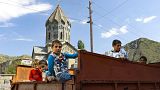 Ethnic Armenian children from Nagorno-Karabakh look from a truck after arriving in Armenia's Goris in Syunik region, Armenia, on Thursday, Sept. 28, 2023.