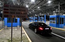 Vehicles pass without stopping at the Bregana border crossing between Croatia and Slovenia after Croatia switched to the Euro and entered Europe's passport-free zone 