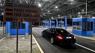 Vehicles pass without stopping at the Bregana border crossing between Croatia and Slovenia after Croatia switched to the Euro and entered Europe's passport-free zone 