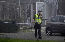 A police officer stands on the site of a powerful explosion that occurred early Thursday morning Sept. 28, 2023.