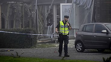 A police officer stands on the site of a powerful explosion that occurred early Thursday morning Sept. 28, 2023.