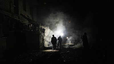 FILE - Resident walks amid debris after a Russian attack in Kherson, southern Ukraine, Nov. 24, 2022. 