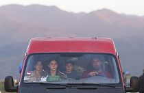 Ethnic Armenians from Nagorno-Karabakh sit inside a minibus on their way to Armenia's Goris in Syunik region, Armenia, on Thursday, Sept. 28, 2023. 