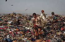 Trash pickers look for recyclable waste at the Bhalswa landfill on the outskirts of New Delhi, India, 2021.