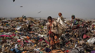 Trash pickers look for recyclable waste at the Bhalswa landfill on the outskirts of New Delhi, India, 2021.