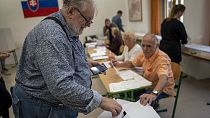 A voter casts his ballot at a polling station in Bratislava, Slovakia, Saturday, Sept. 30, 2023.
