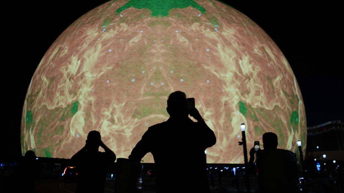 People take pictures during the opening night of the Sphere, Friday, Sept. 29, 2023, in Las Vegas.