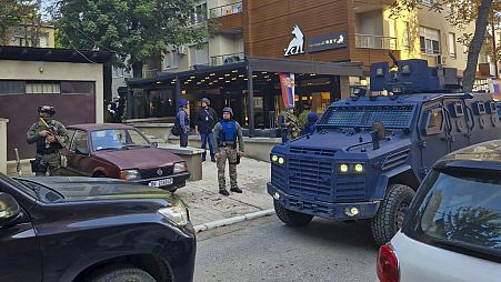 Kosovo police officers search restaurant and building in northern Serb-dominated part of ethnically divided town of Mitrovica, Kosovo, Friday, Sept. 29, 2023.