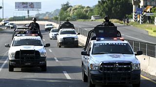 Members of the Civil Guard escort a truck carrying lemons (out of frame) in the Apatzingan-Nueva Italia highway section, Michoacan State, Mexico, on September 20, 2023. 