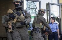 قوات من شرطة كوسوفو ترافق مسلحين صرب إلى خارج مبنى محكمة بعد إطلاق النار المتبادل في شمال كوسوفو قبل عدة أيام