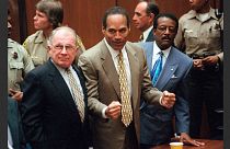 OJ Simpson celebrates after being found 'not guilty' in the murder of his ex-wife and her friend on 3 October 1995.