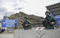 Azerbaijani servicemen guard the Lachin checkpoint on the in Azerbaijan, Sunday, Oct. 1, 2023.