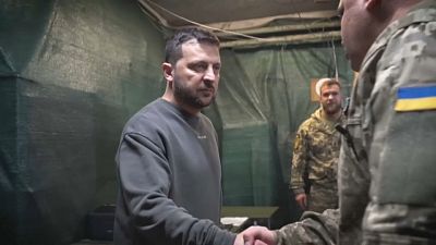 Zelenski saluda a un cargo del ejército durante su visita a posiciones entre las ciudades de Kupiansk y Lyman en la región de Donetsk