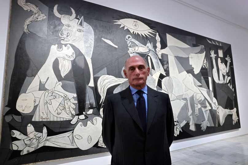 Bernard Ruiz-Picasso poses in front of Picasso's "Guernica" during a press conference at Madrid's Reina Sofia museum.