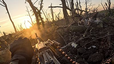 A Ukrainian servicemen fires machine gun towards Russian positions near Andriivka, Donetsk region, Ukraine, Aug. 27, 2023. 