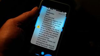 An alert from the Spanish Civil Protection in English is displayed on a phone in Madrid, Spain.
