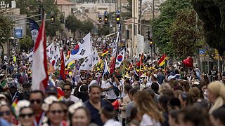 People participate in a traditional Jerusalem March during the Jewish holiday of Sukkot in Jerusalem on Wednesday, Oct. 4, 2023. 