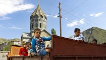 Ethnic Armenian children from Nagorno-Karabakh look from a truck after arriving in Armenia's Goris in Syunik region, Armenia, on Sept. 28, 2023. 