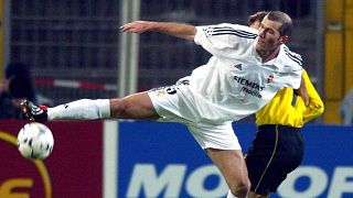 Real Madrid's Zinedine Zidane struggles with Borussia Dortmund's Stefan Reuter during the Champions League second Phase group C match, 2003.