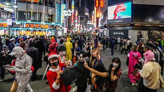  Посетителите на Хелоуин в костюми театралничат за фотоси, до момента в който хиляди се събират в квартал Шибуя през 2021 година 