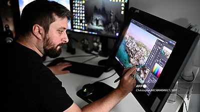 A graphic designer puts the final touches to a scene of Ubisoft's video game "Assassin's Creed Mirage" at the Ubisoft studio in Bordeaux