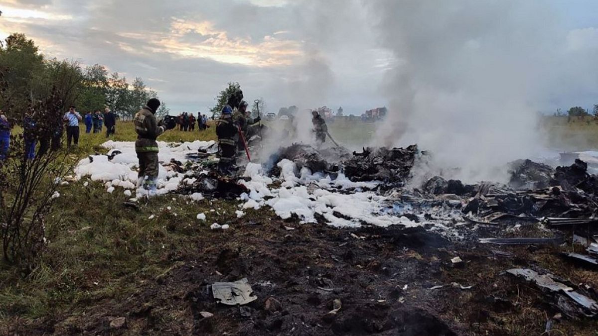 A handout photograph taken and released by Russian Investigative Committee on August 23, 2023, shows rescuers working at the site of a plane crash nearKuzhenkino, Tver region.