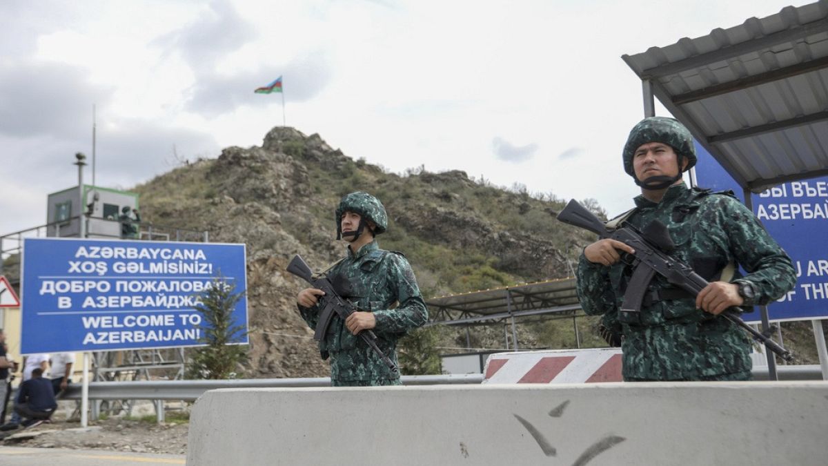 Azerbaijani servicemen guard the Lachin checkpoint on the in Azerbaijan.