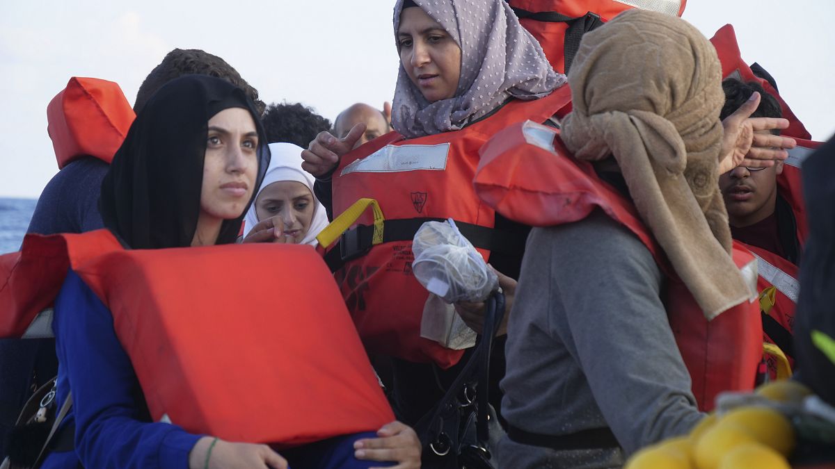 Migrants wear life vests as they are rescued by a MSF (Medecins Sans Frontiers) rescue team boat, after leaving Libya trying to reach European soil, on October 6.