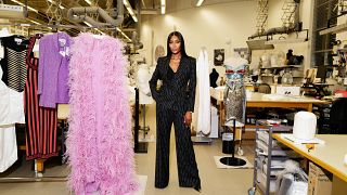 Supermodel Naomi Campbell poses with her clothes, which will be featured in a special exhibition at the V&A museum in London.