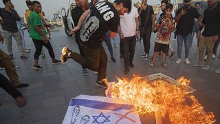Iraqis burn Israeli flags during a rally held in central Baghdad in support of the Palestinians on Saturday