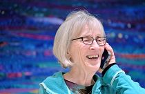 Claudia Goldin speaks to a reporter on the phone in her home in Cambridge, Mass. after learning that she received the Nobel Prize in Economics. 
