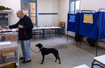 A man votes at a voting station during regional and municipal elections, in Athens