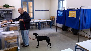 A man votes at a voting station during regional and municipal elections, in Athens