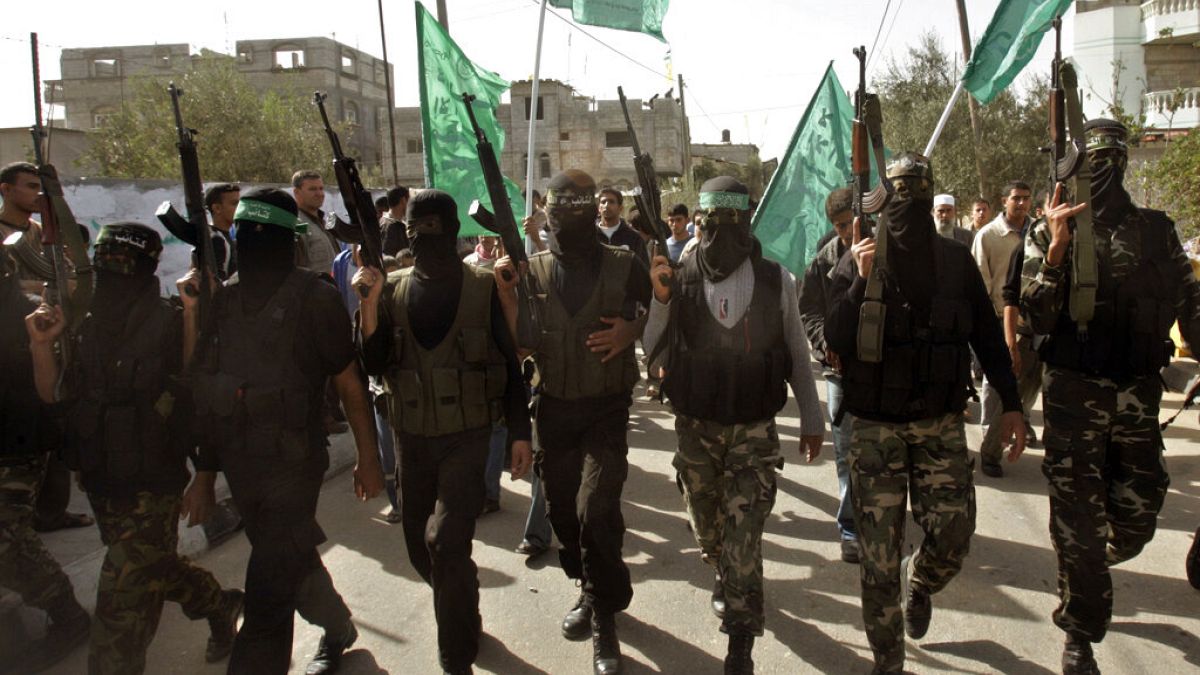 Masked Palestinian Hamas militant attend the funeral of Hamas militant Mahmmed Al Najar in the town of Khan Younis, southern Gaza Strip, Tuesday, Nov. 20, 2007.