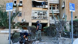 Members of Israeli bomb squad unit inspect a site hit by a rocket fired from the Gaza Strip, in Ashkelon, Israel, Tuesday, Oct. 10, 2023. 