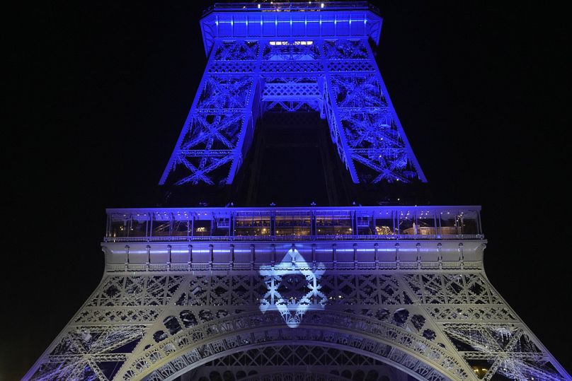 The Eiffel Tower is illuminated with the colors of Israel after a demonstration in a show of support for Israel, Monday, Oct. 9, 2023 in Paris
