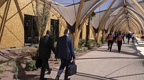 Participants walk inside a convention center hosting the IMF and World Bank annual meetings, in Marrakech, Morocco