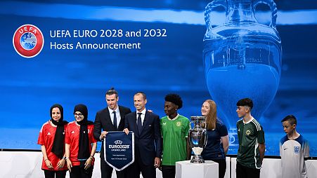 UEFA president Aleksander Ceferin, fourth left, shows the name of UK and Ireland elected to host the Euro 2028 fooball tournament with Gareth Bale