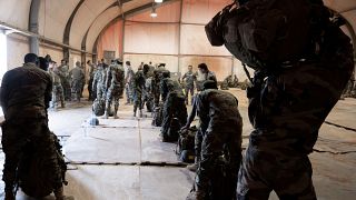 French and Nigerien soldiers prepare for a mission together.