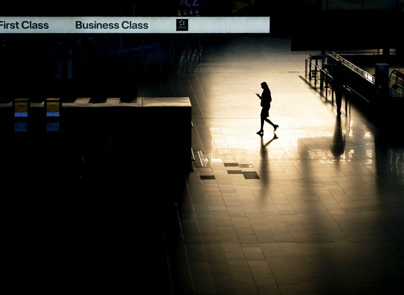 A passenger walks through an almost deserted terminal at the airport in Frankfurt, March 2020