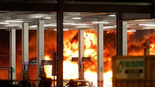 Flames are seen as emergency services respond to a fire in Terminal Car Park 2 at London Luton airport in Luton, Britain, 10 October, 2023. 