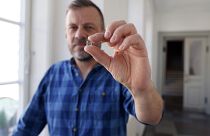 Senior Researcher at the National Museum of Denmark Mads Dengsø Jessen holds a window glass fragment from the Viking Age.