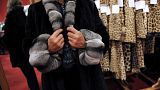 A woman tries on a fur coat, on October 25, 2008 at Hotel Drouot in Paris, two days before fashion items are to be auctioned.