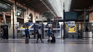 Travelers walk past Eurostar trains linking Paris to London, at the Gare du Nord station, March 2019, Paris.