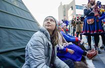 Climate activist Greta Thunberg joins activists wearing a traditional Sami outfits as they sit in protest outside the entrance of Statkraft, 12 October. 