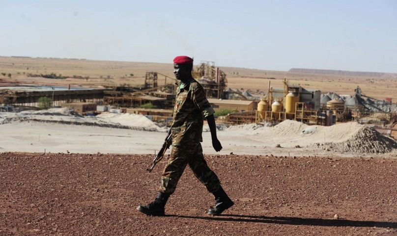 A Nigerien soldier walks outside France's state-owned nuclear giant Areva's uranium mine, September 2010